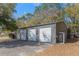 A spacious outbuilding with multiple garage doors offers ample storage and parking space for various needs at 36014 Poinsettia Ave, Fruitland Park, FL 34731