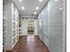 Spacious walk-in closet with frosted glass sliding doors and custom storage at 36014 Poinsettia Ave, Fruitland Park, FL 34731