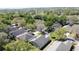 High-angle aerial view of a residential community with mature trees and well-kept lawns at 3725 Westerham Dr, Clermont, FL 34711