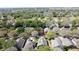 Wide aerial shot showcases neighborhood surrounded by mature trees, with a red marker highlighting the property at 3725 Westerham Dr, Clermont, FL 34711