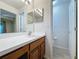 A bathroom with white countertop and wooden cabinets at 3725 Westerham Dr, Clermont, FL 34711