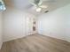 Bright bedroom features wood-look flooring, a ceiling fan, and white French doors leading to another room at 3725 Westerham Dr, Clermont, FL 34711