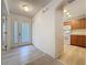 Bright entryway featuring wood flooring, a closet, and an archway leading into the kitchen at 3725 Westerham Dr, Clermont, FL 34711