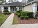 Charming one-story home featuring a neatly landscaped yard and walkway leading to the front door at 3725 Westerham Dr, Clermont, FL 34711