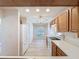 Kitchen featuring white appliances, tile flooring, and wood cabinets at 3725 Westerham Dr, Clermont, FL 34711