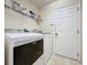 Bright laundry area with full-size Maytag washer and dryer, plus wire shelving at 3725 Westerham Dr, Clermont, FL 34711