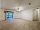 Large living space featuring neutral carpeting and easy access to lanai at 3725 Westerham Dr, Clermont, FL 34711