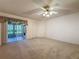 Bright living area with a ceiling fan and sliding glass doors to the lanai at 3725 Westerham Dr, Clermont, FL 34711