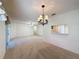 Spacious living room featuring neutral carpet and an elegant chandelier at 3725 Westerham Dr, Clermont, FL 34711