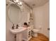 Cozy half-bathroom featuring patterned wallpaper and natural light at 3733 Plantation Blvd, Leesburg, FL 34748