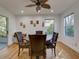 Casual dining room with wood floors, ceiling fan, and sliding door to patio at 3733 Plantation Blvd, Leesburg, FL 34748