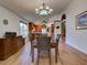 Open concept dining room with wood floors and modern light fixture at 3733 Plantation Blvd, Leesburg, FL 34748