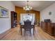 Spacious dining room with unique chandelier and wood floors near french doors at 3733 Plantation Blvd, Leesburg, FL 34748