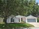 Charming single-story home featuring a two-car garage, well-manicured lawn, and inviting curb appeal at 3733 Plantation Blvd, Leesburg, FL 34748