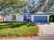 Charming one-story home with lush front yard and attached garage, perfect for suburban living at 3733 Plantation Blvd, Leesburg, FL 34748