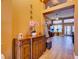 Hallway leads to living room with tiled floors, decorative statues, and display shelves at 3733 Plantation Blvd, Leesburg, FL 34748