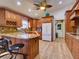 Well-appointed kitchen featuring wood cabinets, granite countertops, and stainless steel appliances at 3733 Plantation Blvd, Leesburg, FL 34748