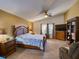 Open primary bedroom with ceiling fan, carpet floors, and large window for natural light at 3733 Plantation Blvd, Leesburg, FL 34748