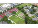 Aerial view of community amenities including tennis courts and a playground at 3773 Eversholt St, Clermont, FL 34711