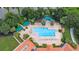 Aerial view of a community pool area with lounge chairs and palm trees at 3773 Eversholt St, Clermont, FL 34711