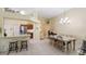 Bright dining room with tile floor, kitchen bar, and modern chandelier at 3773 Eversholt St, Clermont, FL 34711