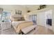 Bright main bedroom featuring a plush bed, neutral décor, and ensuite bathroom at 3773 Eversholt St, Clermont, FL 34711