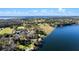 Scenic aerial shot of the home and grounds on the lake showcasing lush landscaping and waterfront views at 37734 N County Road 44A, Eustis, FL 32736