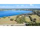 Aerial view of the lakefront property showing citrus trees and the home's proximity to the water at 37734 N County Road 44A, Eustis, FL 32736