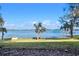 Serene view of a tranquil lake with mature trees and a well-maintained lawn extending to the water's edge at 37734 N County Road 44A, Eustis, FL 32736