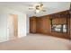 Comfortable bedroom with a wood accent wall, ceiling fan and carpet flooring at 37734 N County Road 44A, Eustis, FL 32736