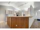 Well-lit kitchen with wooden breakfast bar, overhead lighting, and stainless steel refrigerator at 37734 N County Road 44A, Eustis, FL 32736