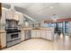 Charming kitchen featuring stainless steel appliances and a seamless view into the adjacent dining area at 37734 N County Road 44A, Eustis, FL 32736