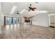 Spacious open-plan living room featuring skylights, ceiling fans, and seamless flow to the dining area at 37734 N County Road 44A, Eustis, FL 32736