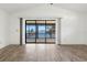 Minimalist living room with sliding glass doors offering serene views of the waterfront at 37734 N County Road 44A, Eustis, FL 32736