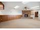 Inviting living room with brick fireplace, wood paneling and skylights at 37734 N County Road 44A, Eustis, FL 32736