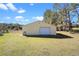 A large outbuilding with a white door and a green hose at 37734 N County Road 44A, Eustis, FL 32736