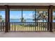 Charming porch overlooking a beautiful lake through a wooden railing at 37734 N County Road 44A, Eustis, FL 32736