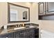 Bathroom features granite countertop, vanity with cabinet storage, and framed mirror at 402 Firewood Ave, Eustis, FL 32726