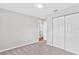 Carpeted bedroom with standard closet, ceiling fan, and neutral colored walls at 402 Firewood Ave, Eustis, FL 32726