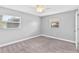 Light-filled bedroom with plush carpet and a ceiling fan at 402 Firewood Ave, Eustis, FL 32726