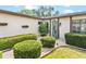 Charming home front featuring an oval glass front door framed by manicured hedges and rock landscaping at 402 Firewood Ave, Eustis, FL 32726