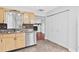 Functional kitchen with stainless steel appliances, light cabinets, and a view into the living room at 402 Firewood Ave, Eustis, FL 32726