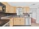 Functional kitchen with stainless steel appliances, light cabinets, and a view into the living room at 402 Firewood Ave, Eustis, FL 32726