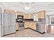 Well-lit kitchen featuring stainless steel appliances, light cabinets, and neutral countertops at 402 Firewood Ave, Eustis, FL 32726