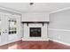 Bright living room with hardwood floors, a fireplace, and French doors leading to the backyard at 402 Firewood Ave, Eustis, FL 32726