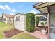 Exterior view of a shed with landscaping, located near the screened-in porch at 402 Firewood Ave, Eustis, FL 32726