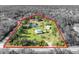 Aerial view of property, pond, land and home outlined in red for clarity and definition at 42141 Chinaberry St, Eustis, FL 32736