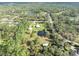 Wonderful aerial photograph exhibiting home, workshop, shed and pond, surrounded by lush trees and adjacent waterways at 42141 Chinaberry St, Eustis, FL 32736