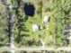 Overhead view captures the residence, large workshop, additional sheds and private pond with mature trees at 42141 Chinaberry St, Eustis, FL 32736