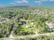 Stunning aerial shot capturing the beautiful home, pond, and wooded acreage that surrounds this property at 42141 Chinaberry St, Eustis, FL 32736